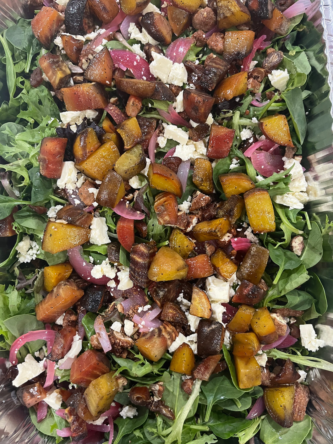 greens salad with roasted beets, dates, candied pecans, pickled red onions and feta